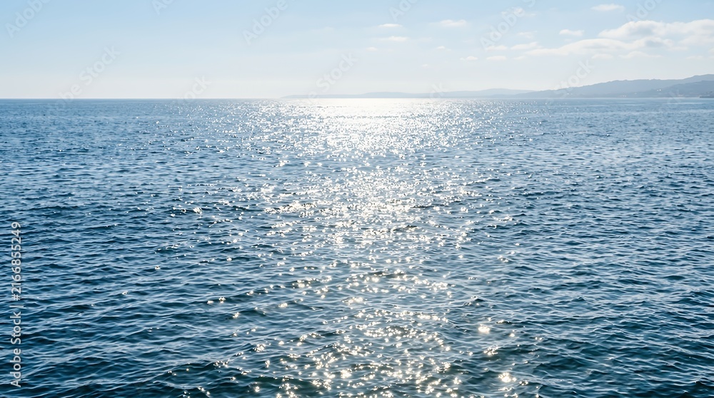 Naklejka premium Tranquil Sunny Ocean Surface Reflecting Bright Seasonal Daylight Ripples Scenic View Surface calm spring sea photo surface sparkling sunshine ocean water sun reflection light shimmer glitter peaceful