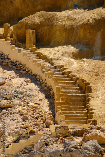 Fotografie Ancient stone staircase carved into a dry desert mountain hillside