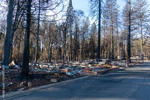 Obraz na płótnie Burned Vehicle Beside Home Foundation After Wildfire