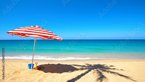 Tropical beach with red striped umbrella and sand toys.