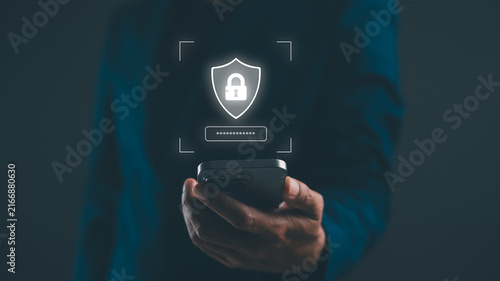 A person holding a smartphone with a digital shield and padlock icon representing cybersecurity and data protection.
