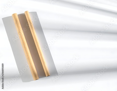 Two wooden pencils on white with artistic shadows.