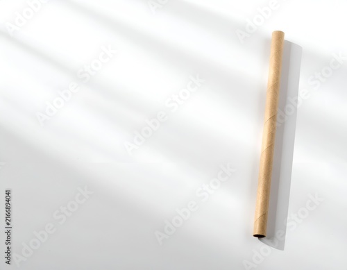 Vertical wooden pencil casting shadow on white.