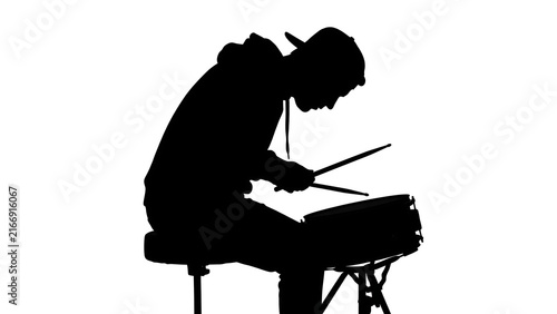 Silhouette of drummer playing on white background.