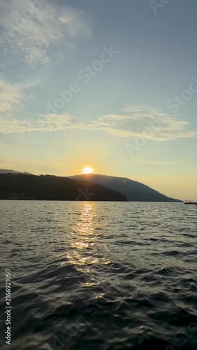 Boat riding in Iboih, Sabang, Indonesia. Serene boat ride on calm waters during a vibrant sunset