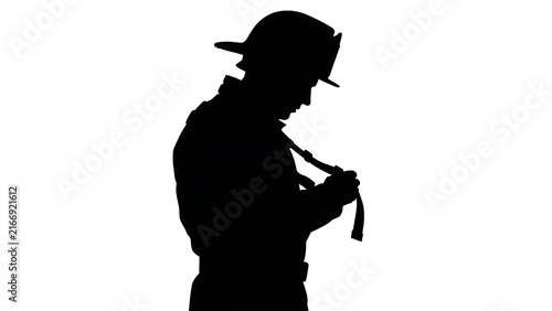 Silhouette of firefighter with hose white background.