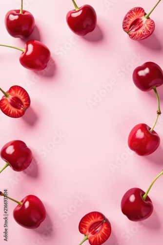 A Delightful Arrangement of Fresh, Ripe Cherries on a Pink Background, Perfect for Summer Recipes and Culinary Designs