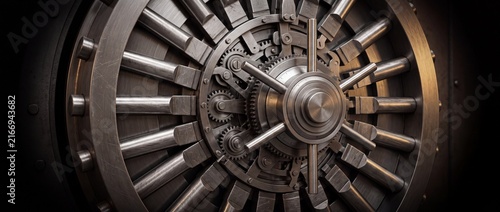 Massive steel vault door with complex mechanical gears and locking mechanism for secure bank storage safety and financial asset protection