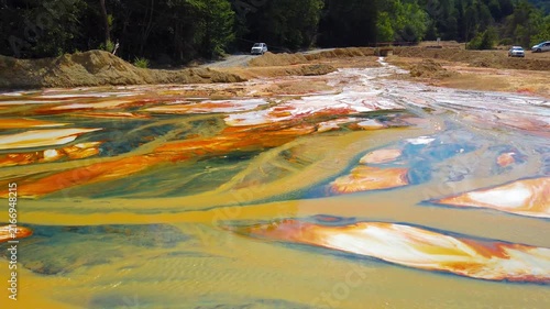 A stream with industrial pollutants at Geamana, a toxic tailings lake in Alba County, Romania. Pollution in nature. Toxic substances spilled in nature. Environment bacground