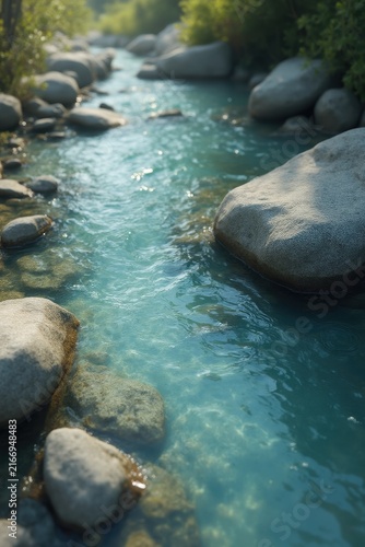 Turquoise stream flowing between smooth rounded rocks, shimmering under sunlight with clear rippling water, surrounded by green vegetation, capturing serene natural beauty.
