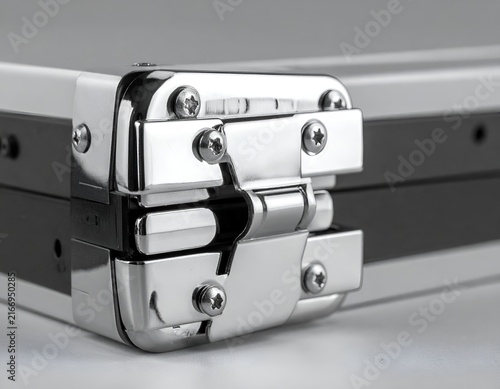 Chrome metal briefcase latch close-up view.