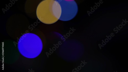 Abstract blurred colored lights on a dark background with soft bokeh circles