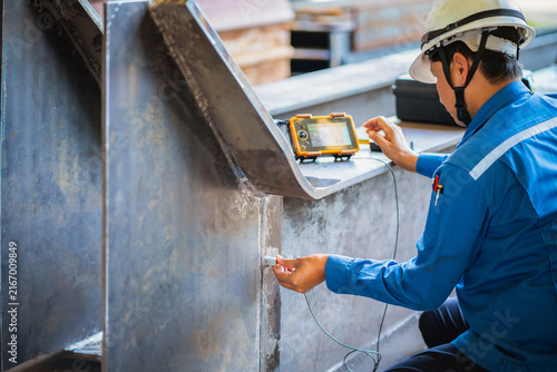 UT, Ultrasonic testing to detect imperfection or defect in welding of steel plate structure in factory. NDT Inspection.