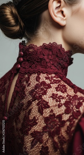 Woman wearing burgundy lace dress with high collar neck detail close up shot