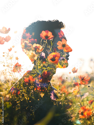 Double exposure silhouette of a mans profile filled with vibrant wildflowers.