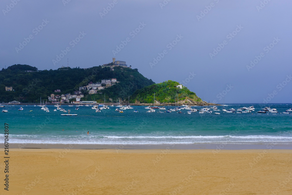 Fototapeta premium La Concha Beach and Bay with Santa Clara Island and Mount Igueldo in San Sebastian, Basque Country, Spain
