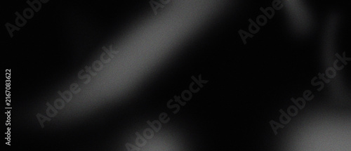 Abstract blurred light streaks on a dark grainy black