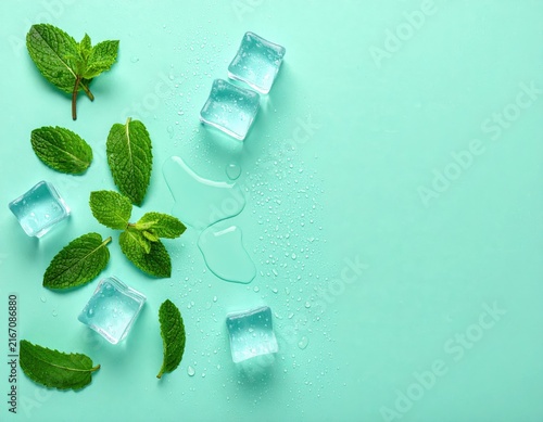 Fresh mint leaves with ice cubes on turquoise background