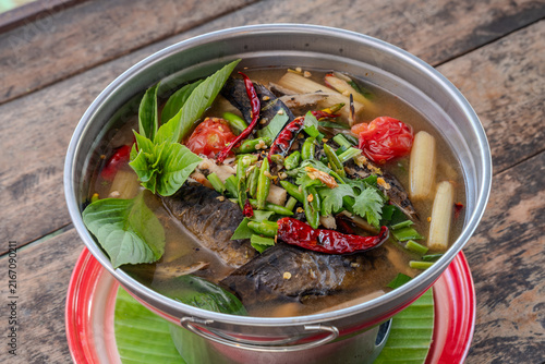 Spicy Thai Fish Soup with Herbs and Red Chilies in Hot Pot