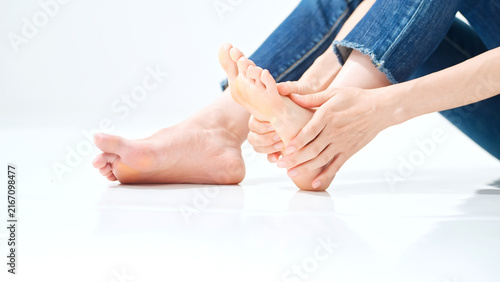 Bild auf Leinwand A woman massaging the soles of her feet