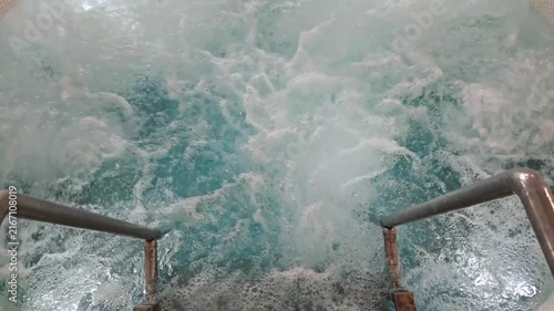 Turbulent Pool Water Beside Metal Handrail