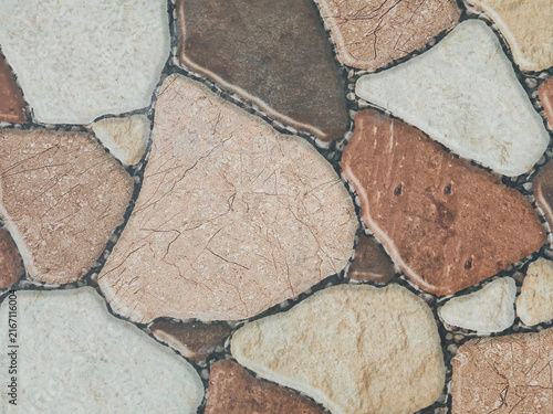 view of natural stone mosaic tiles in warm beige and brown tones, ideal for interior design, architecture, background textures, and decorative construction material visuals.
