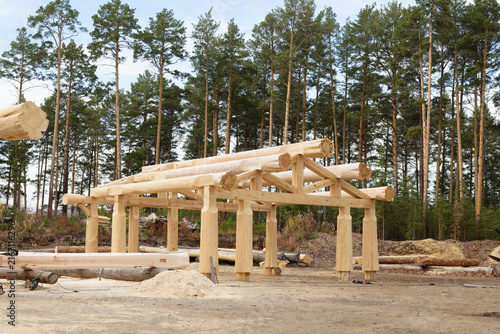 The construction site of a wooden house. Traditional log cabin built from wood logs. Cottage house design