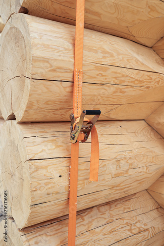 The construction site of a wooden house. Traditional log cabin built from wood logs on sunny summer day. Cottage house design