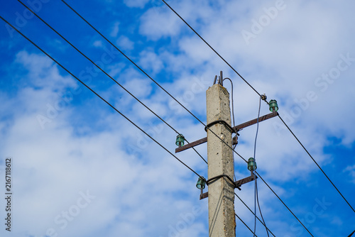 Utility pole with electrical wires and insulators.