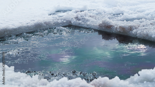 Foto Hole in the ice carved out for swimming, hardening winter.
