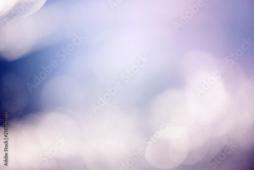 A dreamy blue  purple background with soft bokeh lights, subtle grain, tiny dust particles. The vintage texture gives it a nostalgic, cinematic feel, perfect for adding atmosphere to creative designs.