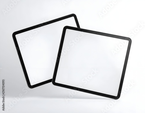 Two blank tablets leaning together on white background