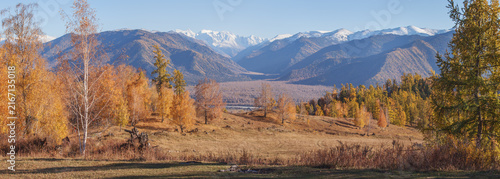 Mountain autumn landscape, snow-capped peaks and forest, picturesque valley, panoramic