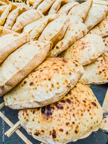 Egyptian baladi Bread Food Photography, breakfast, lunch, dinner,  traditional whole wheat flatbread known for its hearty texture and nutty flavor, selective focus, shallow depth of field, Cairo Egypt