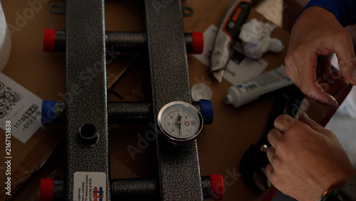 Bild auf Leinwand Highly engaging premium closeup photo of a plumber assembly home heating manifold with a modern temperature sensor tool