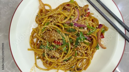 Chinese Restaurant Table with Noodles on Plate and Wonton Soup in Bowl – Traditional Dumplings and Noodle Dish