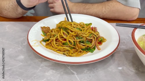 Chinese Restaurant Table with Noodles on Plate and Wonton Soup in Bowl – Traditional Dumplings and Noodle Dish