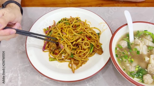Chinese Restaurant Table with Noodles on Plate and Wonton Soup in Bowl – Traditional Dumplings and Noodle Dish