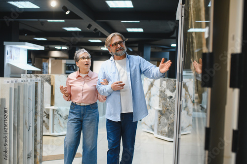 Fotografie Senior couple choosing tiles for home renovation project