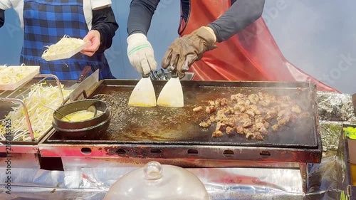Korean Street Food – Grilling Skewers and Beef Steak Over Open Flame at Outdoor Market Stall