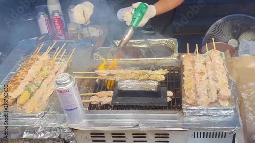 Korean Street Food – Grilling Skewers and Beef Steak Over Open Flame at Outdoor Market Stall