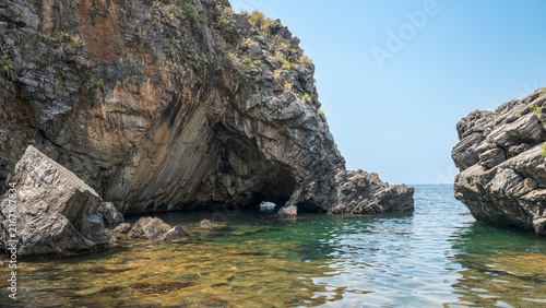 Canvastavla Scenic view of a natural sea cave and rugged coastal cliffs at the famous Cala Jannita black sand beach in Maratea, Basilicata, Italy
