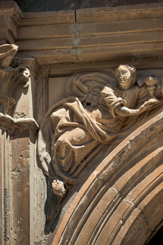 фотографія Weathered figurative stone relief with reclining carved human figure and flowing