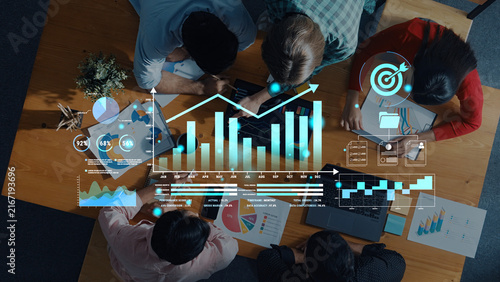 Fotografie Group of Diverse Professionals Collaborating on Data Analysis and Strategic Planning with Digital Graphs and Charts in Modern Office Environment Haptic