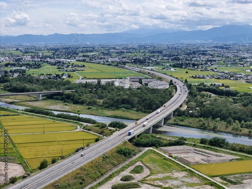 Cuadro en lienzo Aerial view of a curved highway bridging a river