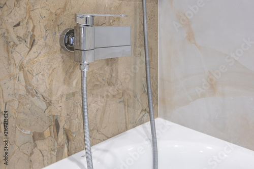  details of corner with water tap sink with faucet with soap and shampoo dispensers in expensive bathroom in rustic eco style
