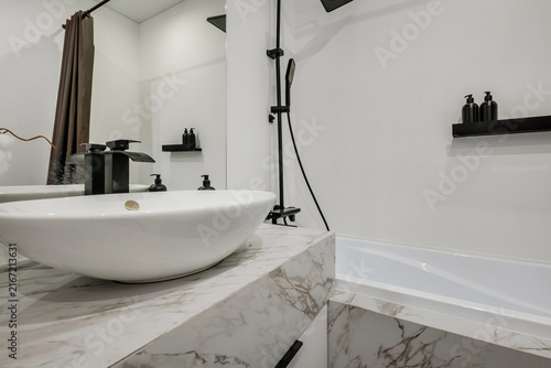  details of corner with water tap sink with faucet with soap and shampoo dispensers in expensive bathroom in rustic eco style