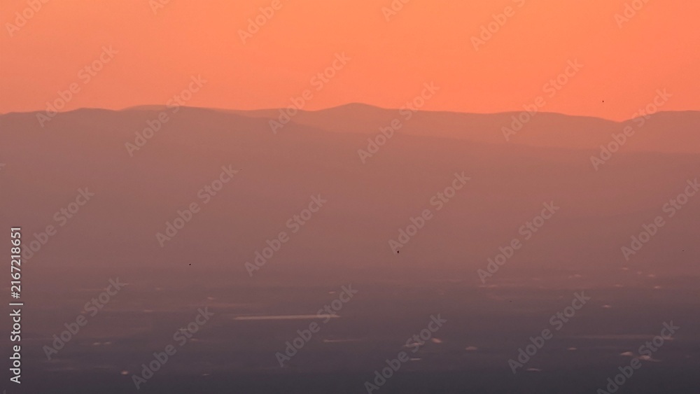 Fototapeta premium Sunset and a warm orange sky and a natural landscape