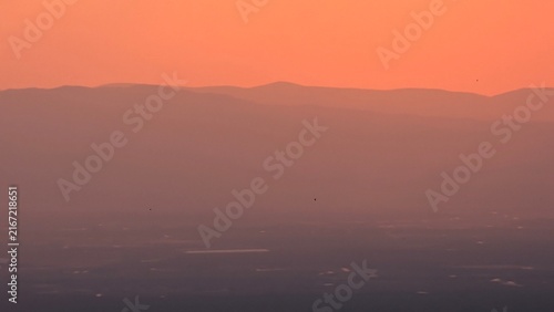 фотографія Sunset and a warm orange sky and a natural landscape