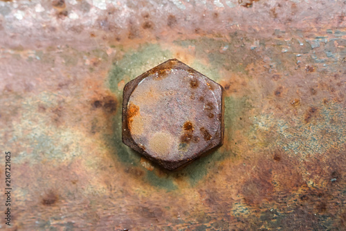 Obraz na plátne Rusty metal bolt on weathered copper surface with corrosion, oxidation, texture,
